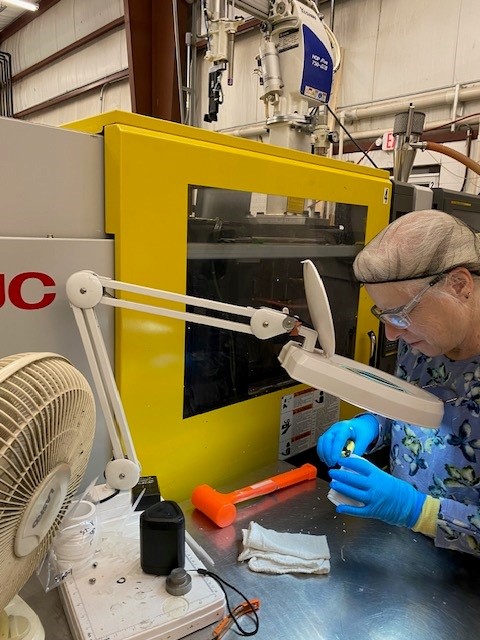 production worker inspecting parts